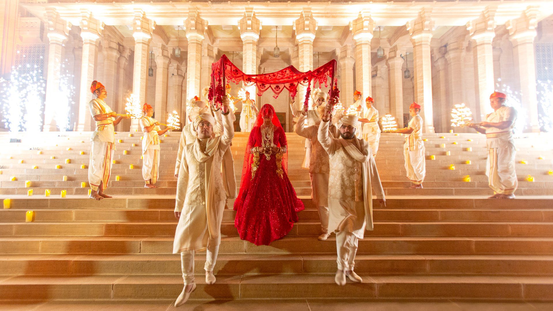 A bride and groom are standing on steps.